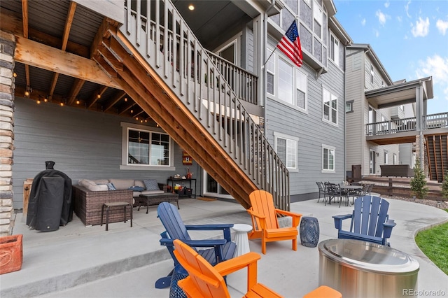 view of patio / terrace featuring outdoor dining space, an outdoor living space, and stairway