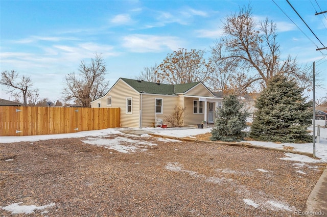 view of snow covered rear of property