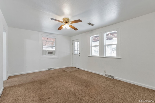 carpeted empty room featuring ceiling fan