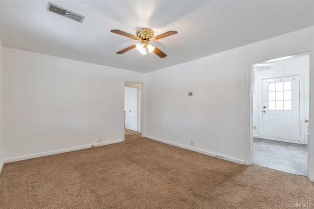 carpeted spare room with ceiling fan