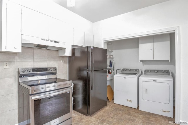 kitchen with black refrigerator, tasteful backsplash, white cabinetry, washing machine and clothes dryer, and electric range