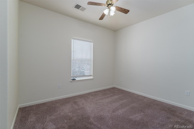 empty room with carpet, visible vents, ceiling fan, and baseboards