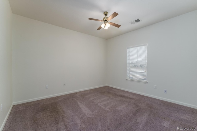 spare room with carpet floors, baseboards, visible vents, and ceiling fan