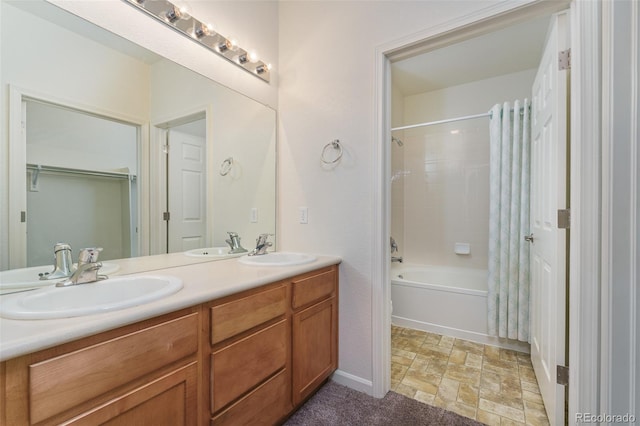 full bathroom featuring double vanity, shower / tub combo, and a sink