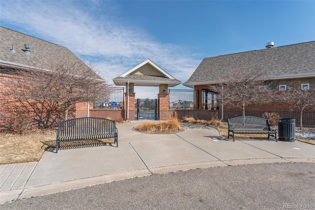 view of patio / terrace with central air condition unit, a fenced front yard, and a gate