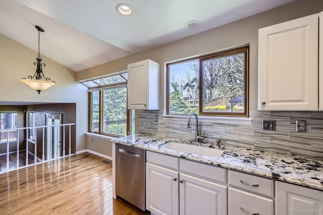 9916 Spring Hill Ln, Highlands Ranch, CO 80129 - kitchen featuring stainless steel dishwasher, vaulted ceiling, white cabinets, backsplash, and recessed lighting