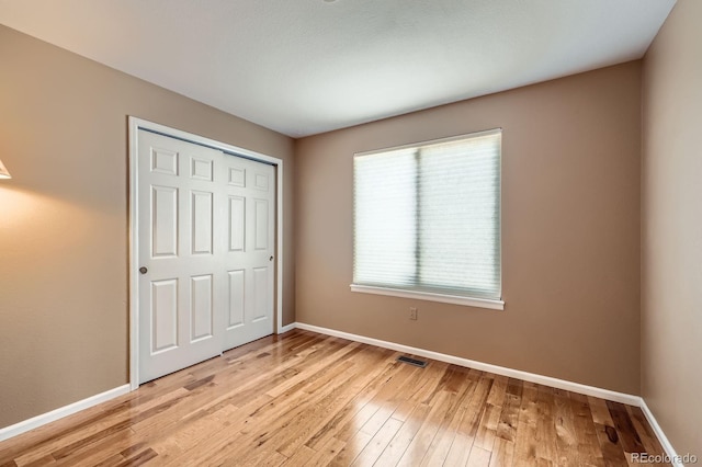 9916 Spring Hill Ln, Highlands Ranch, CO 80129 - unfurnished bedroom featuring light wood finished floors and a closet