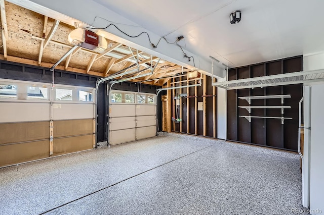 9916 Spring Hill Ln, Highlands Ranch, CO 80129 - garage featuring a garage door opener and freestanding refrigerator