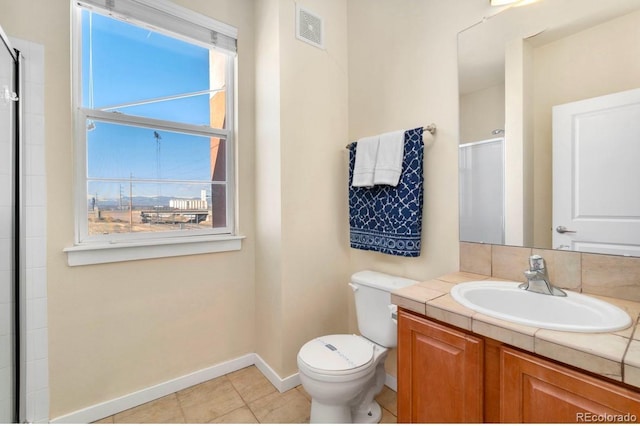 full bathroom with toilet, a shower with shower door, vanity, visible vents, and tile patterned floors