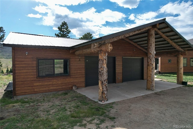 log home featuring a garage