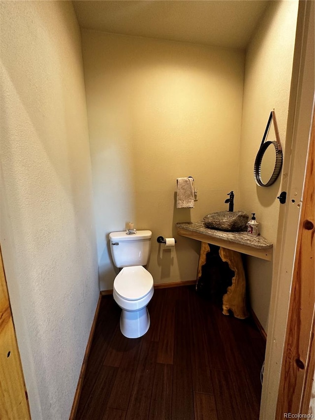 bathroom with sink, hardwood / wood-style flooring, and toilet