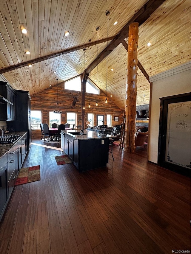 kitchen with wooden ceiling, high vaulted ceiling, dark wood-type flooring, and an island with sink