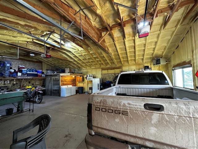 garage with independent washer and dryer and a garage door opener