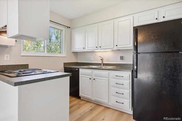 kitchen with white cabinetry, sink, light hardwood / wood-style flooring, and black appliances