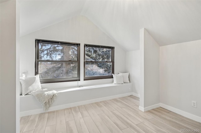 interior space with light hardwood / wood-style flooring and lofted ceiling