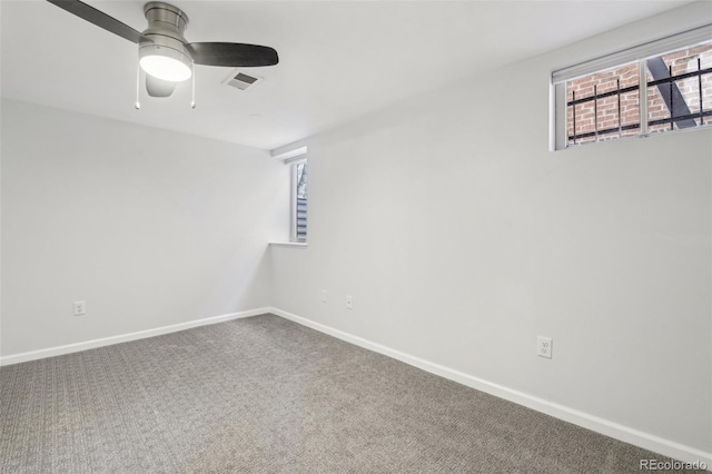 spare room featuring ceiling fan and carpet floors