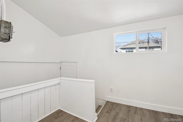 interior space featuring vaulted ceiling and hardwood / wood-style flooring