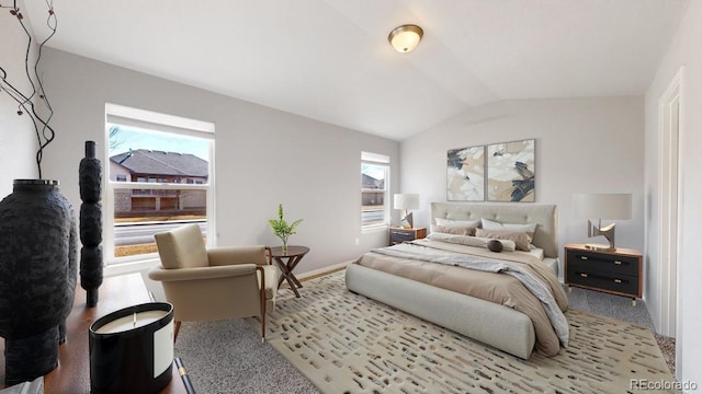 carpeted bedroom featuring multiple windows, baseboards, and vaulted ceiling