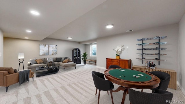 rec room with recessed lighting, light colored carpet, visible vents, and baseboards