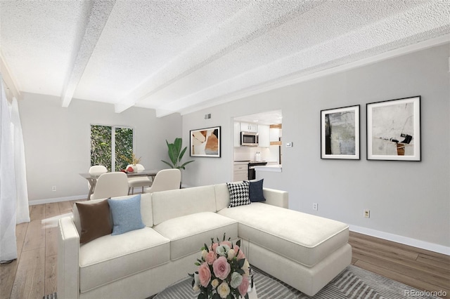 living room with light hardwood / wood-style flooring, beam ceiling, and a textured ceiling