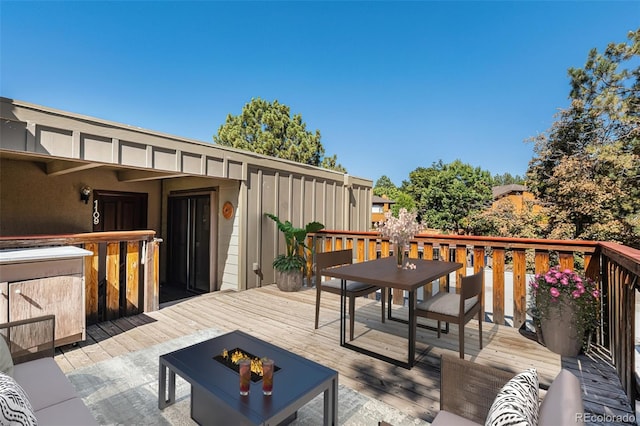 wooden terrace with a fire pit