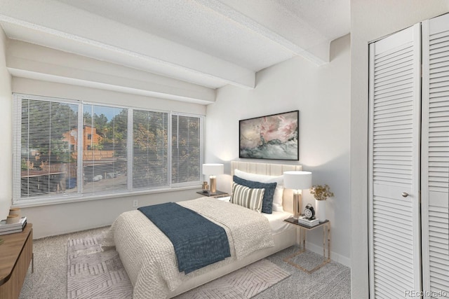 bedroom featuring beamed ceiling, a textured ceiling, and carpet