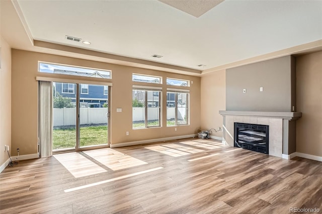 4625 Walden Ct, Denver, CO 80249 - unfurnished living room with light wood-type flooring, a fireplace, and baseboards