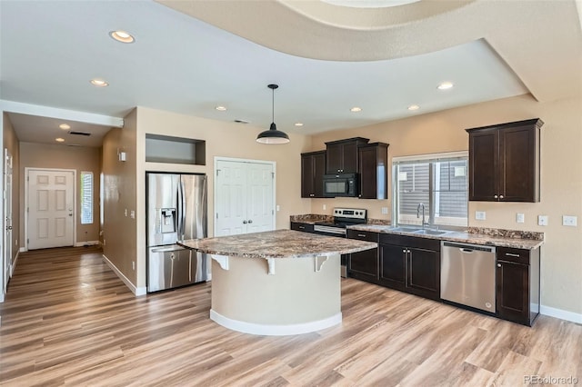 4625 Walden Ct, Denver, CO 80249 - kitchen featuring stainless steel appliances, a sink, light wood-style flooring, baseboards, and recessed lighting