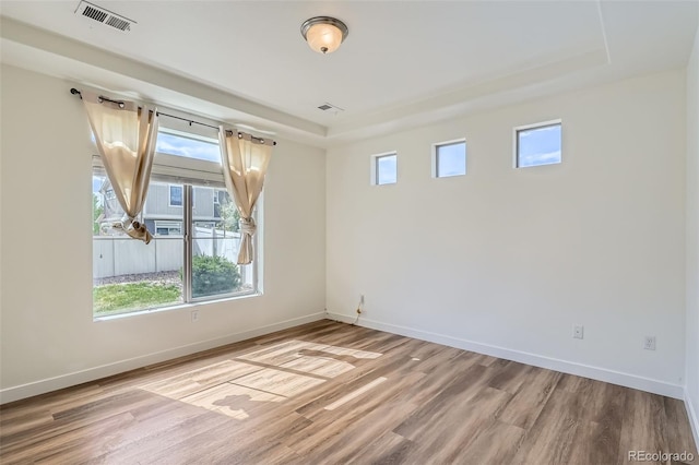 4625 Walden Ct, Denver, CO 80249 - unfurnished room featuring a raised ceiling, baseboards, and wood finished floors
