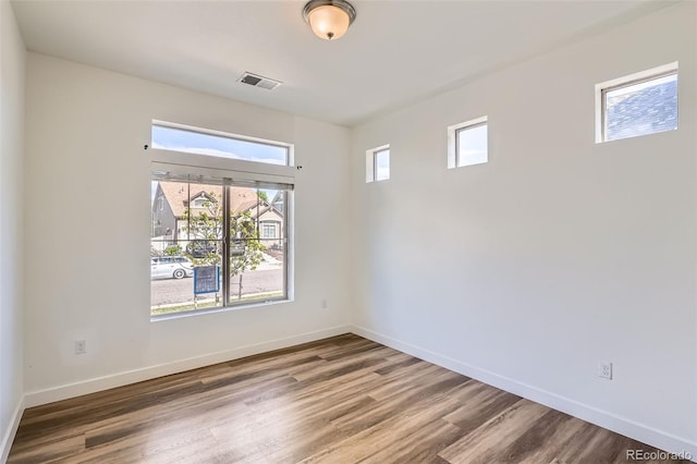 4625 Walden Ct, Denver, CO 80249 - empty room with plenty of natural light, wood finished floors, and baseboards