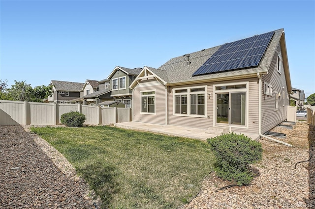 4625 Walden Ct, Denver, CO 80249 - back of property with solar panels, roof with shingles, a patio, and entry steps