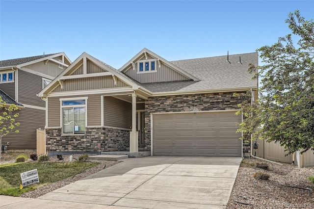4625 Walden Ct, Denver, CO 80249 - craftsman inspired home with stone siding, driveway, an attached garage, board and batten siding, and roof with shingles