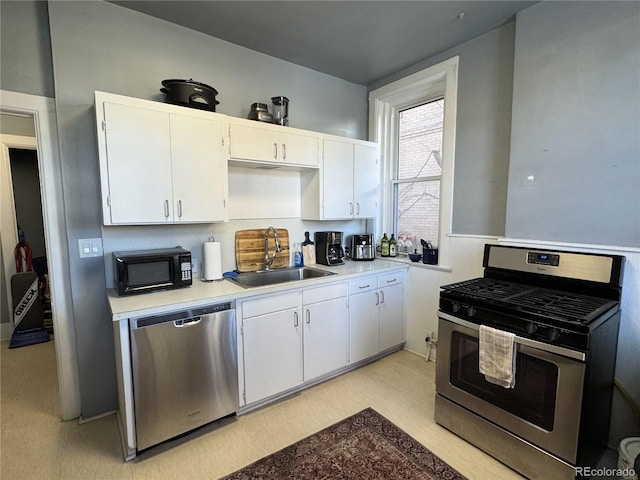 kitchen with white cabinetry, stainless steel appliances, and sink