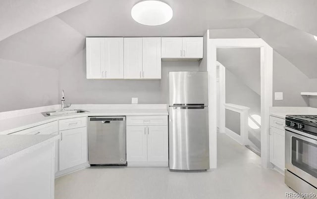 kitchen with white cabinetry, sink, lofted ceiling, and appliances with stainless steel finishes