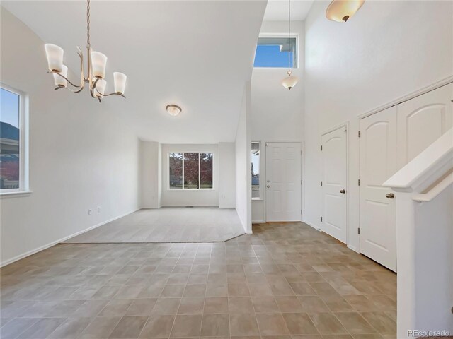 8612 13th St, Greeley, CO 80634 - foyer entrance with an inviting chandelier, a towering ceiling, and plenty of natural light
