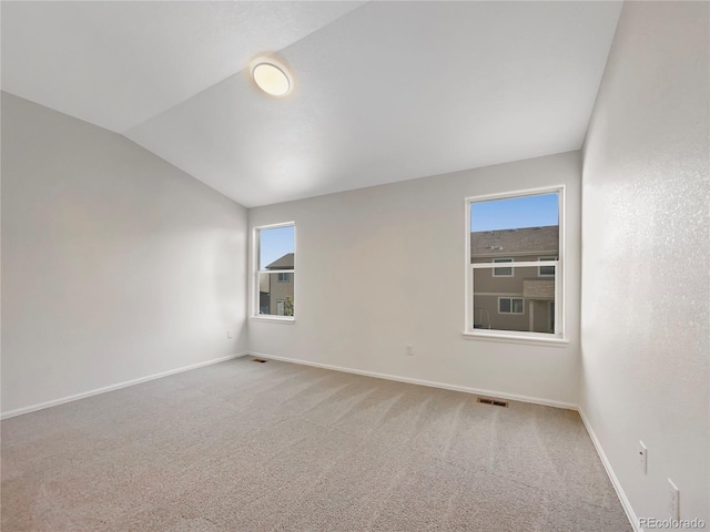 8612 13th St, Greeley, CO 80634 - carpeted spare room with lofted ceiling, visible vents, and baseboards