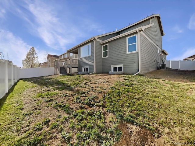 8612 13th St, Greeley, CO 80634 - rear view of house featuring central air condition unit, a fenced backyard, and stairway