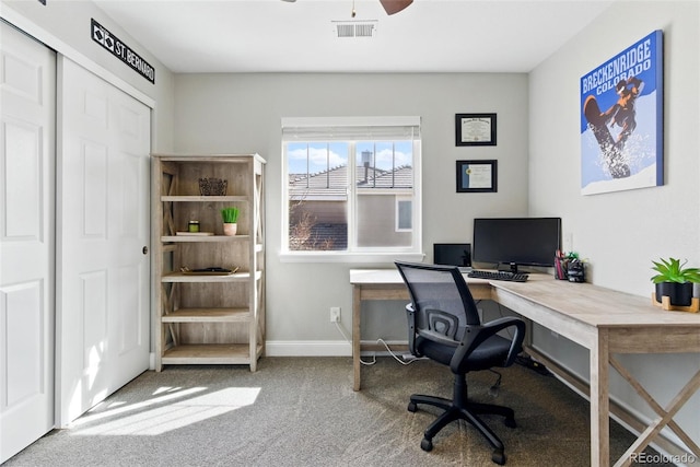 office with visible vents, carpet floors, baseboards, and a ceiling fan