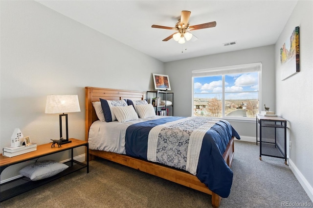 carpeted bedroom with visible vents, a ceiling fan, and baseboards