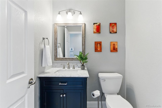 bathroom featuring toilet and vanity