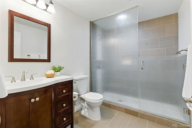 full bath with tile patterned floors, vanity, toilet, and a shower stall