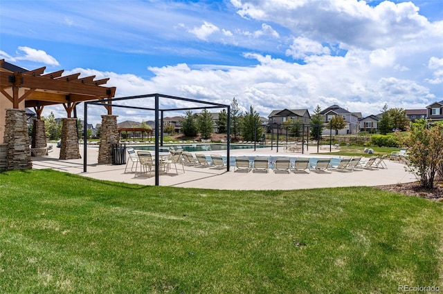 exterior space with a swimming pool, a lawn, a pergola, and a patio