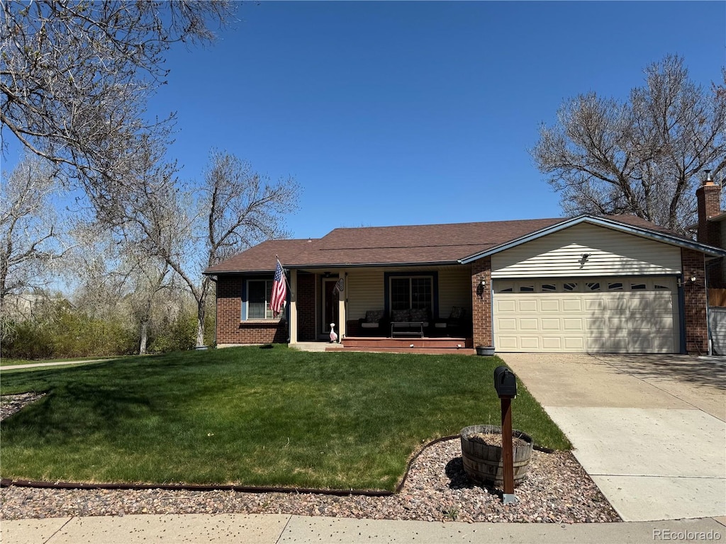 single story home featuring a front yard, brick siding, a garage, and a porch