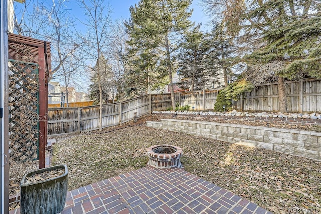 view of yard with a patio area and an outdoor fire pit