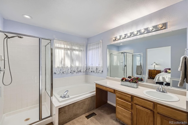 bathroom featuring vanity and separate shower and tub