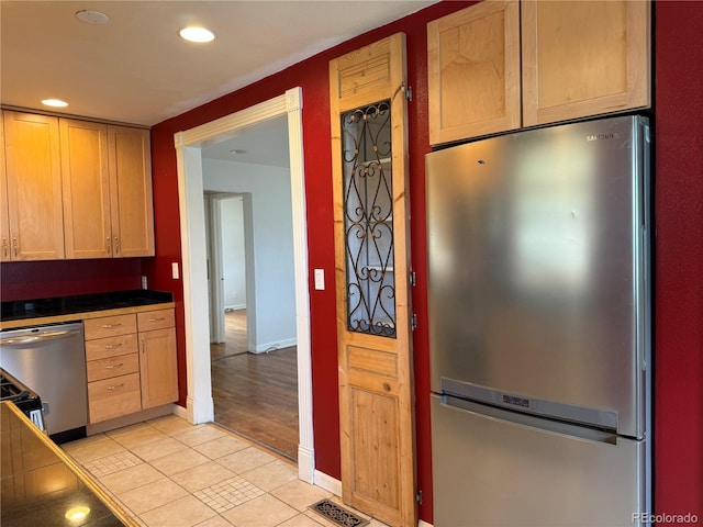 5618 Carr St, Arvada, CO 80002 - kitchen with stainless steel appliances, light tile patterned floors, recessed lighting, dark countertops, and baseboards