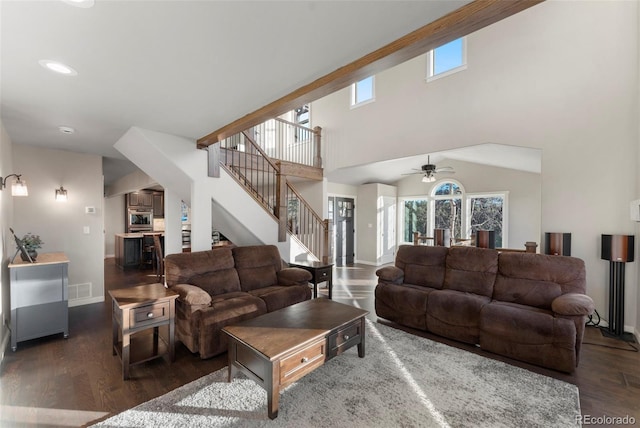 living room with dark hardwood / wood-style floors, ceiling fan, and high vaulted ceiling