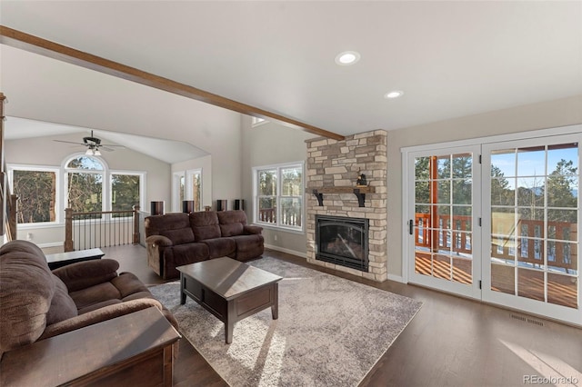 living room with dark hardwood / wood-style flooring, vaulted ceiling with beams, plenty of natural light, and ceiling fan