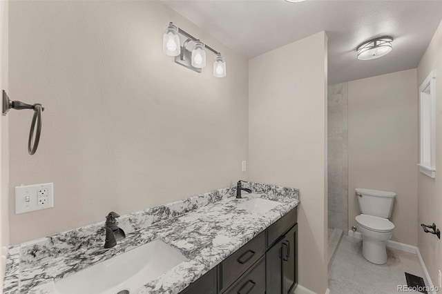 bathroom with tile patterned flooring, vanity, and toilet