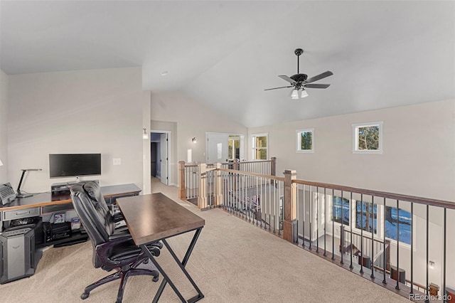 carpeted office space featuring ceiling fan and vaulted ceiling